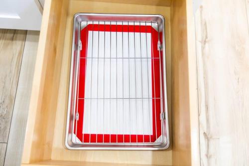 a red window with a metal grate on a wall at Stylish Casita min from the beach ! in San Juan Capistrano