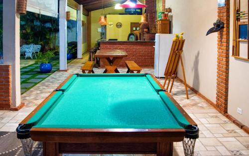 a pool table in the backyard of a house at Chácara Flores de Maio in Atibaia