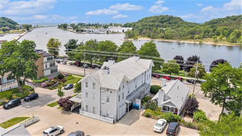 an aerial view of a large white house next to a river at Harbor House Inn in Grand Haven