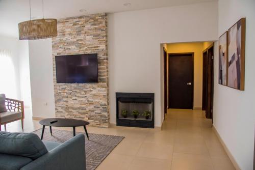 a living room with a couch and a fireplace at Voyage Vacation Club in Rosarito