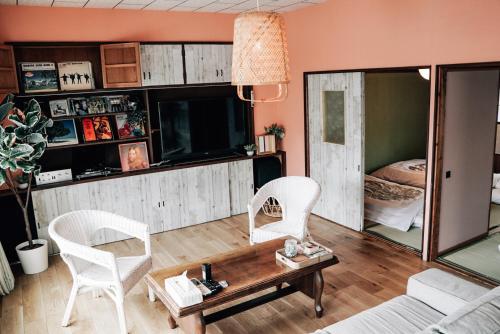 a living room with a couch and chairs and a table at Tipy records inn house in Odawara