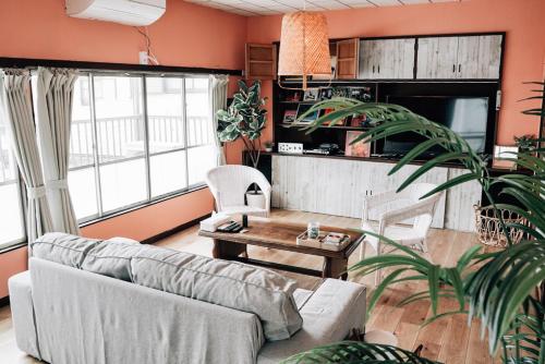a living room with a couch and a table at Tipy records inn house in Odawara