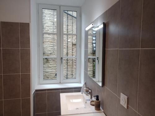 a bathroom with a sink and a window at Appartement Eden in Saint-Père