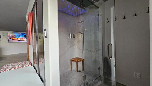 a shower with a wooden stool in a bathroom at LVStripHouse JC406 - Modern Superior Studio Condo - Sleeps 6 in Las Vegas