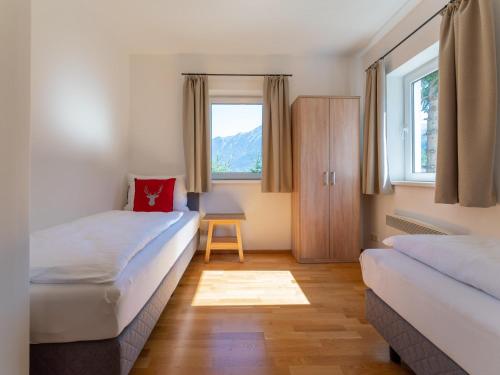 a room with two beds and a window at Villa Taube in Bad Gastein