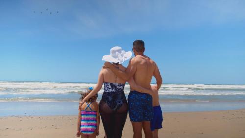 a group of people standing on the beach at Voyage Vacation Club in Rosarito