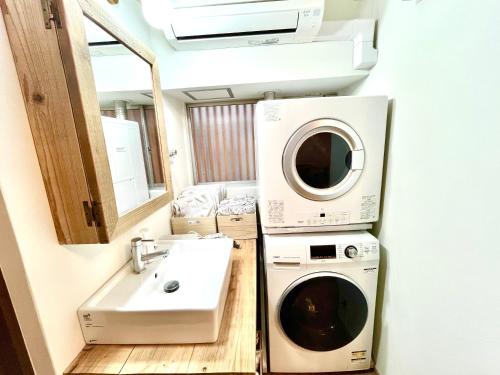 a bathroom with a washing machine and a sink at 木庵 "Moku-an"Tiny house go to Kyoto Nara in 1 hour in Osaka