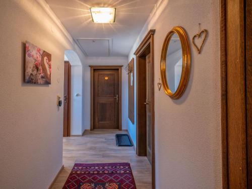 a hallway with a door and a mirror on the wall at Ferienwohnung Krimbacher in Brixen im Thale