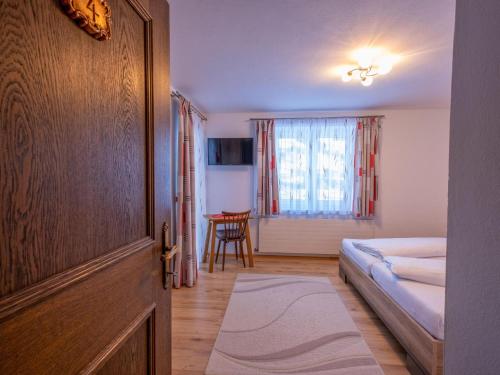 a hotel room with a bed and a table at Ferienwohnung Krimbacher in Brixen im Thale