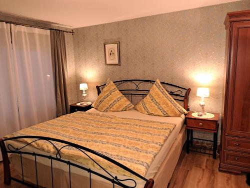 ミュルハイム・アン・デア・モーゼルにあるHéritage B&Bのベッドルーム1室(ベッド1台、ナイトスタンド2台、ランプ2つ付)