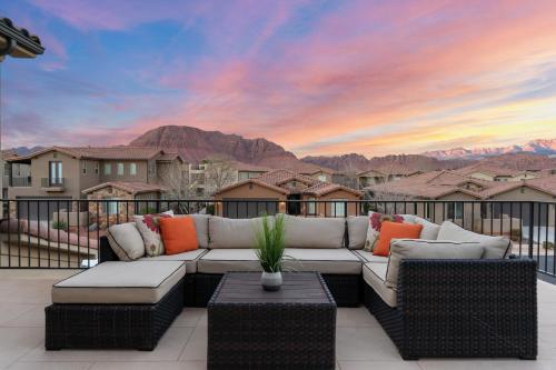 a couch on a balcony with a view of the mountains at Double the Fun combo - Canyon Springs 76 and Desert Moose 75 home in Santa Clara