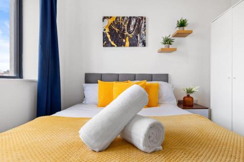 1 dormitorio con 1 cama de color amarillo y blanco en OCEAN BLUEZ 1bdr city centre en Hemel Hempstead
