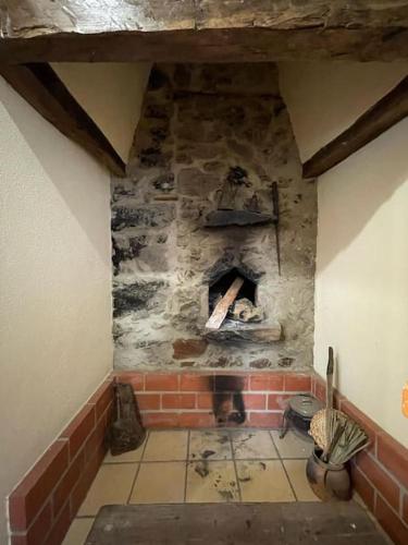 a stone oven in a room with a brick wall at Casa da Bivó in Figueiró dos Vinhos