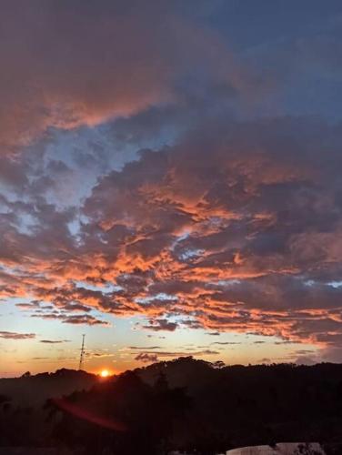 a sunset with clouds in the sky at Casa Típica La Cruz in Monteverde Costa Rica