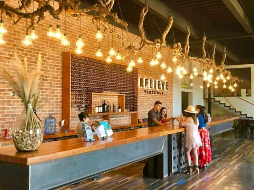 a group of people standing at a bar at Voyage Vacation Club in Rosarito