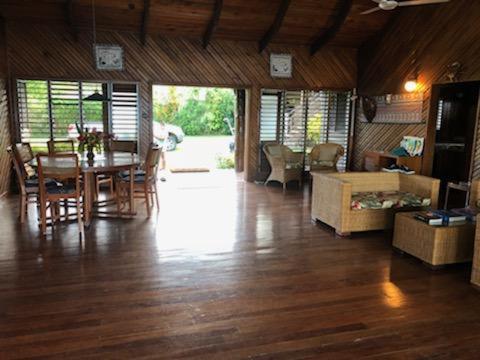 a living room with a table and a dining room at Sere Ni Ika in Matei