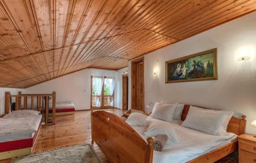 a bedroom with a bed and a wooden ceiling at Family friendly house with a parking space Dragovanscak, Prigorje - 22529 in Jastrebarsko