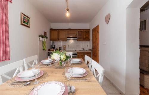 a dining room with a table with plates and glasses at Family friendly house with a parking space Dragovanscak, Prigorje - 22529 in Jastrebarsko