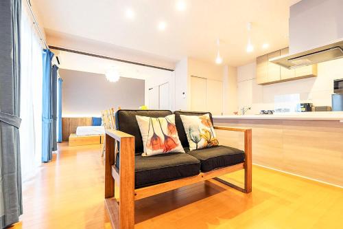 a couch with two pillows on it in a kitchen at Chura Minpaku Ishigaki in Ishigaki Island