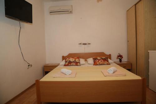 a bedroom with a bed with two towels on it at Apartments by the sea Milna, Hvar - 22619 in Hvar