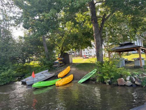 a group of kayaks are lined up on a river at The Villas on Lake George in Diamond Point