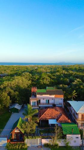 an overhead view of a house with the ocean in the background at Pousada Origin in Guarda do Embaú