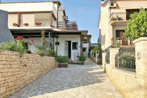 an alley in a house with a brick wall at Apartments and rooms by the sea Zambratija, Umag - 22685 in Savudrija