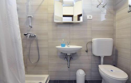 a bathroom with a white toilet and a sink at Apartments and rooms by the sea Zambratija, Umag - 22685 in Savudrija