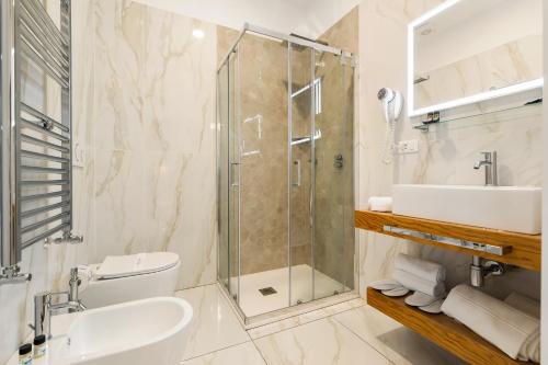 a bathroom with a shower and a sink and a toilet at AlbaDea Déco&Jacuzzi in Rome
