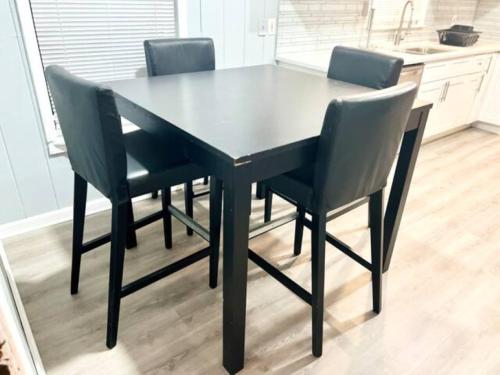 a black dining room table and chairs in a kitchen at King Deluxe Suite Room 2 in Atlanta