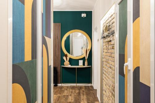 a hallway with a mirror and green walls at AlbaDea Déco&Jacuzzi in Rome