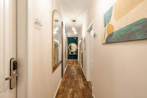 a hallway with paintings on the walls at AlbaDea Déco&Jacuzzi in Rome