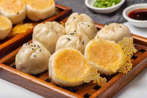 a tray of dumplings with black seeds on it at Shangri-La Changchun in Changchun