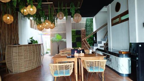 a restaurant with chairs and a table in a room at Sangkar Cottage & Eatery in Seturan