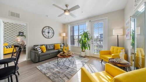 a living room with a couch and a table at Stylish 2BR Corporate Stay Pool Balcony #2 in Tampa