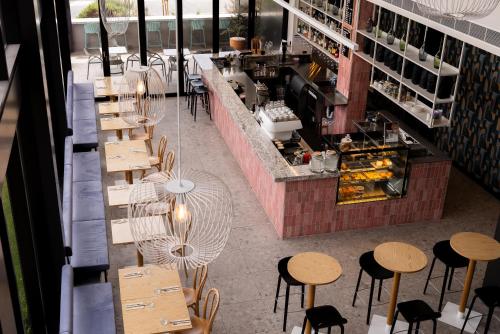 an overhead view of a restaurant with tables and chairs at Mantra Tonsley Adelaide in Adelaide