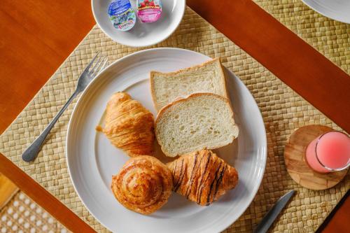 a plate of bread and croissants on a table at Akhyana Village in Jimbaran