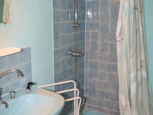 a blue bathroom with a sink and a shower at Gîte Saint-Laurent-de-Lin, 4 pièces, 6 personnes - FR-1-381-501 in Saint-Laurent-de-Lin