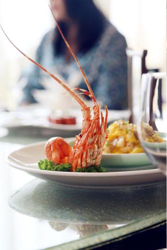 a plate of food with shrimp on a table at Shangri-La Qinhuangdao in Qinhuangdao