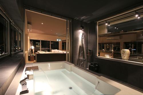 a bathroom with a large bath tub in a room at Sky Cuculu Ishigakijima in Ishigaki Island