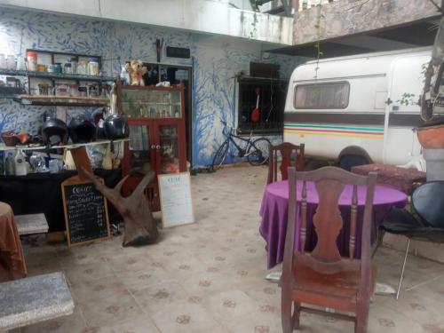 a room with a table and chairs and a van at Good Nice GN in Bangkok