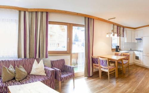 a living room with a couch and a table at Apartment Alouette in Samnaun