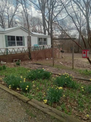 a garden in front of a house with a fence at Grays fishing and hunting rental in Aurora