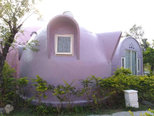 a purple house with a window on the side of it at Kenting Ha-Bi Star Fort in Hengchun South Gate