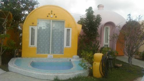 a small house with a pool in the yard at Kenting Ha-Bi Star Fort in Hengchun
