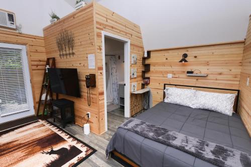 アトランタにあるPeaceful Barn Getaway Fire Pit & Daybed FREE PKのベッドルーム1室(ベッド1台付)、テレビが備わります。