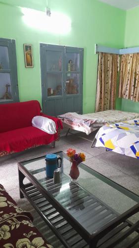 a living room with a couch and a coffee table at Karunanidhan Homestays in Ayodhya