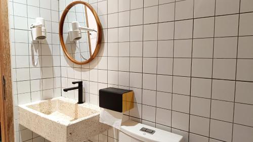 a bathroom with a sink and a mirror at Sangkar Cottage & Eatery in Seturan