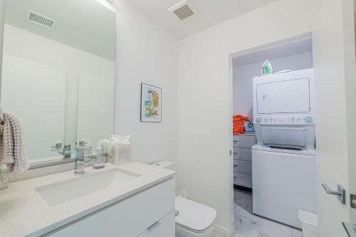 a white bathroom with a sink and a stove at Zanjero by AvantStay Mins from Downtown Palm Springs Private Terrace Shared Pool in Palm Springs