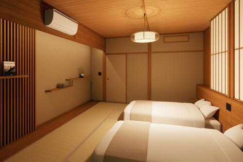 a bedroom with two beds and a window at Ooedo Onsen Monogatari Premium Hotel Sokan in Matsushima